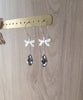Rhodium plated dragonfly earrings with "Black Silver Night" Swarovski crystal drops on display