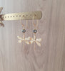 18K gold plated dragonfly earrings featuring "Black Silver Night" Swarovski crystals on jewellery display