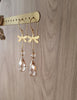 18K gold plated dragonfly earrings featuring Golden Shadow Swarovski drops on jewellery display