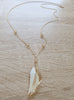 Long 18K gold plated necklace featuring a Golden Shadow Swarovski crystal tooth-pendant
