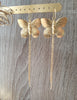 Stylish long-length 18K gold plated statement butterfly earrings on display.