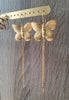 Stylish long-length 18K gold plated statement butterfly earrings on display.