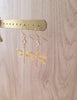 18K gold plated dragonfly and diamond-cut crystal earrings on jewellery display
