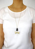 Woman wearing a long 18K gold plated dragonfly necklace with Black Swarovski crystals