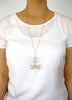 Woman wearing a long 18K gold plated dragonfly necklace with Golden Shadow Swarovski crystals