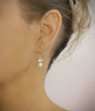 Gold earrings with white freshwater pearls and Austrian crystal butterflies