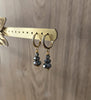 18K goldplated hoop earrings featuring Black Silver Night Swarovski crystals on display