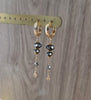18K gold plated hoop earrings with Black Silver Night Swarovski crystals on display