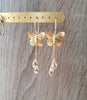18K gold plated butterfly earrings with Golden Shadow Swarovski crystal drops on display.