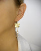 Woman wearing 18K gold plated butterfly earrings with Golden Shadow Swarovski crystal drops.