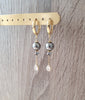 18K gold plated hoop earrings featuring dark grey Austrian pearls and crystal drops on display.