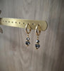 18K gold plated huggie earrings featuring Black Silver Night Swarovski crystals.