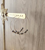 18K gold plated hoop earrings with Black Silver Night Swarovski crystals on display.