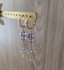 18K gold plated hoop earrings with Tanzanite Swarovski crystals on display