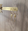 18K gold plated seashell earrings featuring crystal charms on display