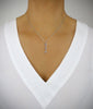 Woman wearing a short silver plated triple-swirl coin necklace with Swarovski crystals charms