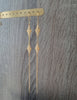 Long-length 18K gold plated double flowerlink earrings on display.