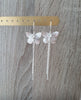 Rhodium plated butterfly dangle earrings with Swarovski crystal charms on jewellery display