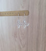 Silver butterfly earrings with clear Swarovski crystals on display