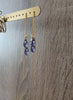 18K gold plated threader chain earrings handmade with sparkling Tanzanite Swarovski crystal drops on display.