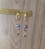 18K goldplated hoop earrings with Tanzanite heart and Swarovski crystals on display