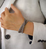 Beige triple wrap leather bracelet with Swarovski crystals and magnetic lock worn on hand