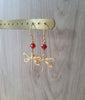 18K gold plated dragonfly earrings featuring sparkling "Scarlet Red" Swarovski crystals on display.
