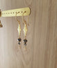 18K gold plated flowerlink earrings handmade with sparkling "Black Silver Night" Austrian crystals on display.