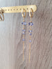 18K gold plated long-length hoop earrings featuring Tanzanite Swarovski crystals on display.
