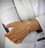 Woman wearing 18K gold plated dragonfly bracelet adorned with sparkling Golden Shadow Swarovski crystals.