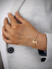 Woman wearing 18K gold plated dragonfly bracelet adorned with sparkling Golden Shadow Swarovski crystals.