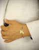 Woman wearing 18K gold plated butterfly bracelet adorned with Black Silver Night Swarovski crystals.