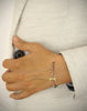 Woman wearing 18K gold plated dragonfly bracelet decorated with Black Silver Night Swarovski crystals.