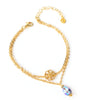 18K gold plated double chain flower bracelet decorated with a Tanzanite AB Swarovski crystal drop.