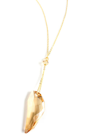 Long necklace with Golden Shadow tooth-pendant and crystals