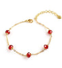 Delicate 18K gold plated chain bracelet decorated with five faceted Scarlet Red Swarovski crystals and adjustable lobster clasp fastening