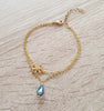18K gold plated double chain flower bracelet decorated with a Tanzanite AB Swarovski crystal drop.