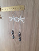 Rhodium plated dragonfly earrings handmade with "Black Silver Night" Swarovski crystal drops on display