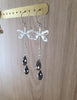 Rhodium plated dragonfly earrings with "Black Silver Night" Swarovski crystal drops on display