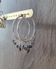 Rhodium plated hoop earrings with Black Silver Night Swarovski crystals on jewellery display