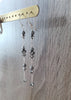 Long-length silver plated earrings with "Black Silver Night" Swarovski crystals and pearls on display