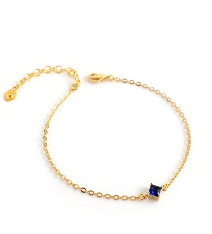 Dige Designs gold bracelet with a Majestic blue crystal