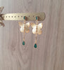 18K gold plated butterfly stud earrings with Emerald drops on display
