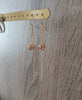 18K gold plated dangle earrings with "Light Amethyst" Swarovski crystal balls on display