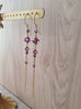 Long-length 18K gold plated earrings with Amethyst Swarovski crystals on display