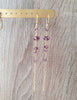 Long-length 18K gold plated earrings with Amethyst Swarovski crystals on display