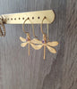 18K gold plated dragonfly earrings with Tanzanite crystals on jewellery display