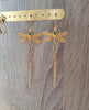 18K gold plated dragonfly earrings handmade with Emerald Green Austrian crystal charms on display