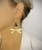 Woman wearing 18K gold plated statement dragonfly earrings with black Swarovski crystals