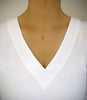 Woman wearing short 18K gold plated necklace with a Black Silver Night Swarovski crystal drop and charm